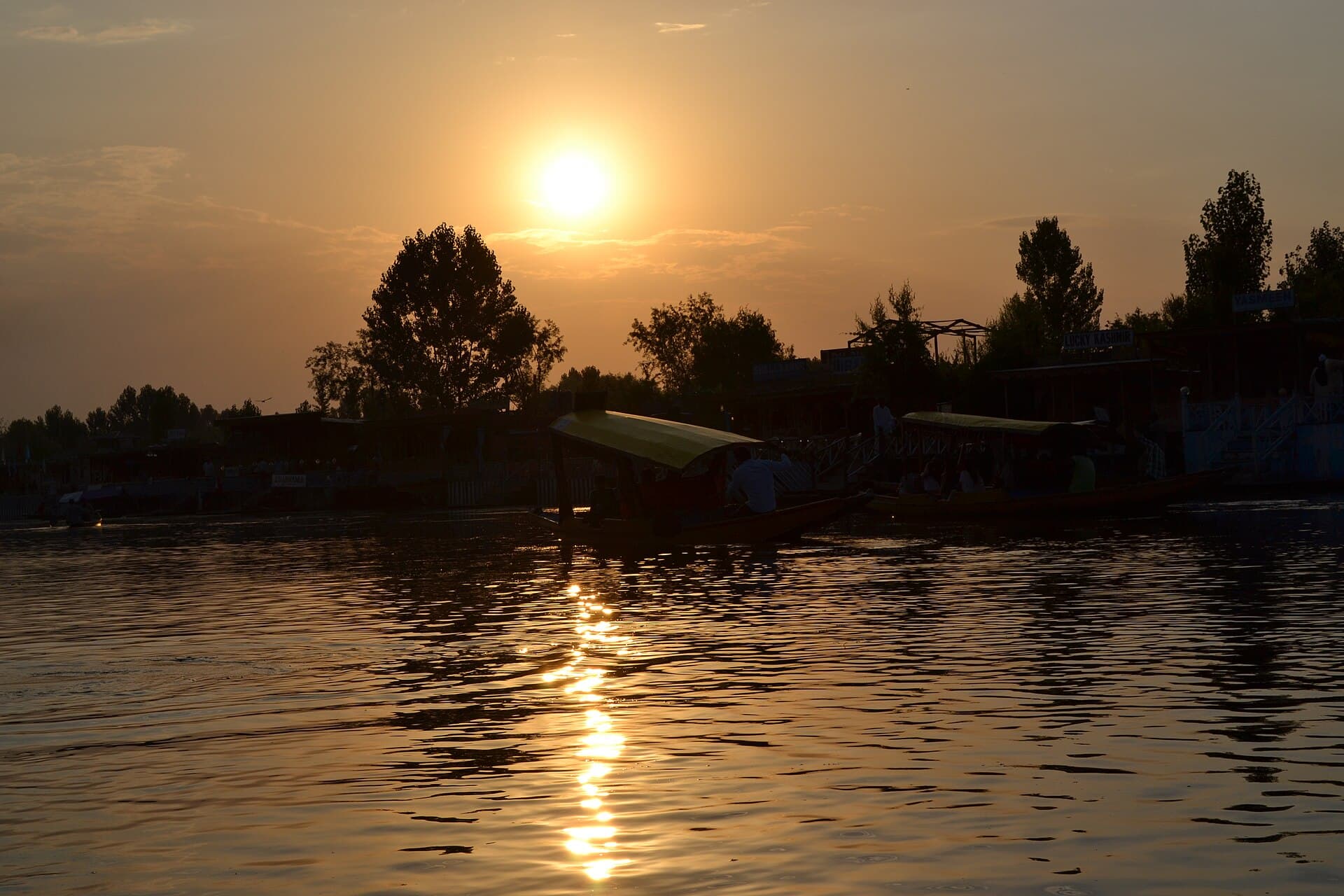 A wooden shikara on the still water of Dal Lake, Srinagar